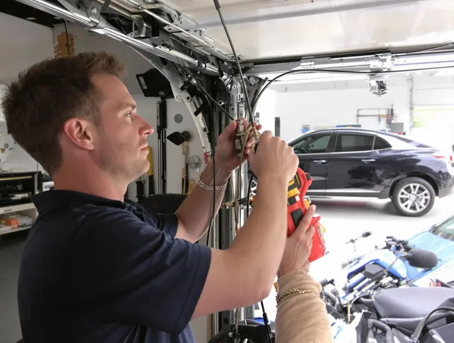Newtown Garage Door Repair safety certified technician performing cable replacement in Newtown